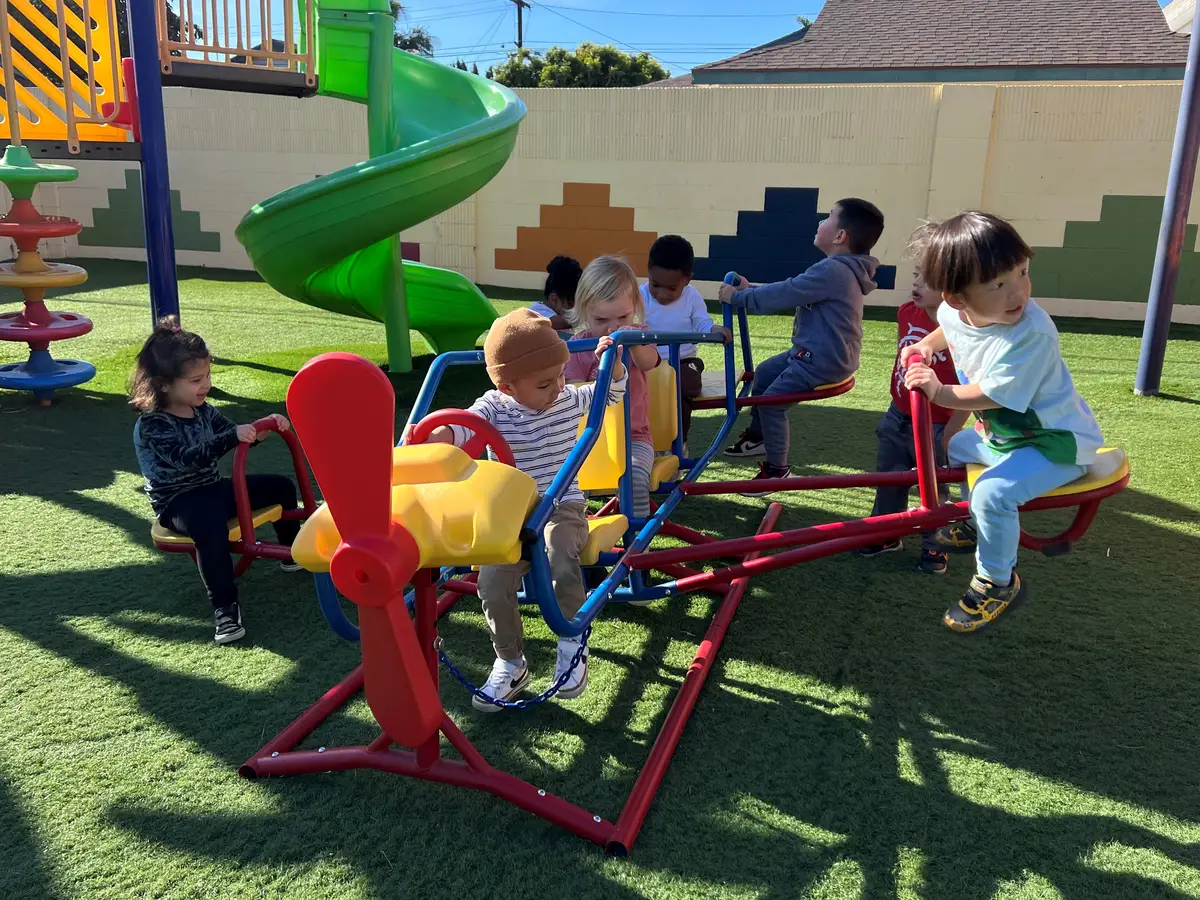 Children playing outdoors at Newport Ave Preschool in Tustin, welcoming families from across Orange County