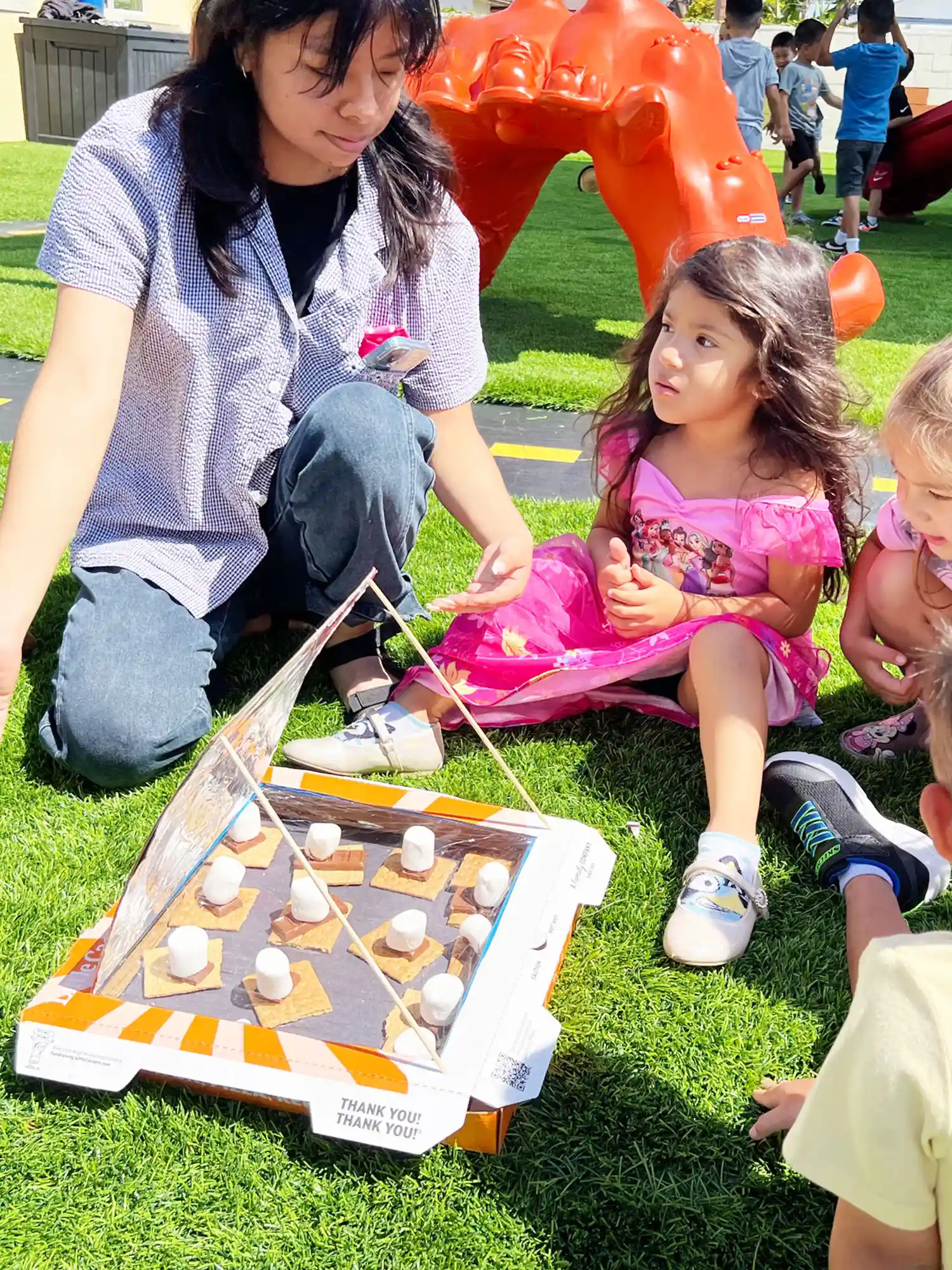 Young children exploring a colorful preschool ball pit during summer activities