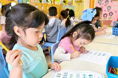 4-year-old Pre-K child at Newport Ave Preschool focused on a paper assignment during structured academic learning