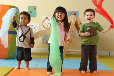 Children participating in dance and fitness enrichment at Newport Ave Preschool doing a group physical activity