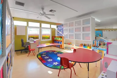 Bright, well-equipped toddler classroom with developmentally appropriate toys and learning materials at Newport Ave Preschool