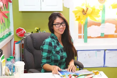 Newport Ave Preschool teacher looking confidently at the camera, representing a passionate and caring educator
